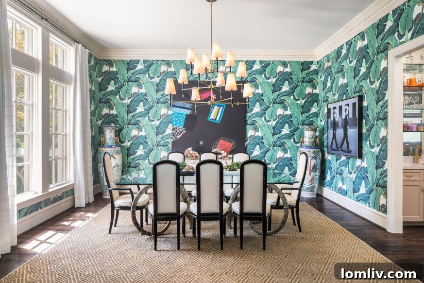 Dining room of English Cotswold manor after renovation, showcasing bold wallpaper and modern lighting