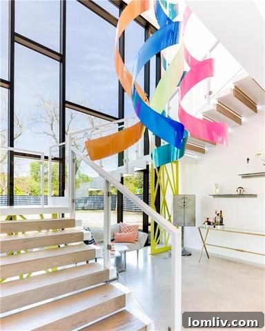 Floating stairwell with a custom, colorful ribbon-like sculpture and light installation.