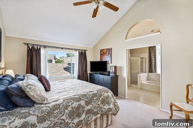 Luxurious Master Bedroom with Vaulted Ceilings and Abundant Light