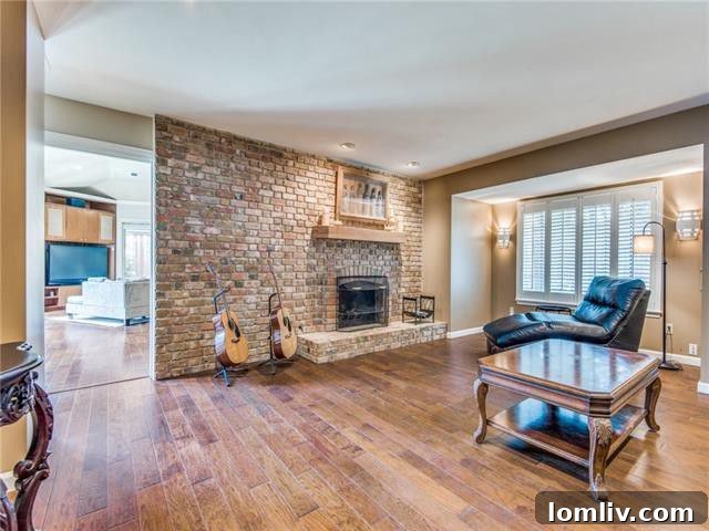 Spacious and elegant living area with gleaming hardwood floors and ample natural light in a Farmers Branch luxury home.