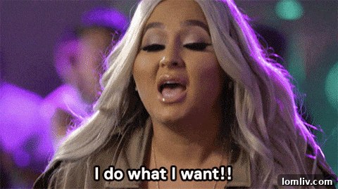 A stunning wide aerial shot of Sommarøy island, showcasing its rugged coastline, scattered traditional houses, and the vast expanse of the shimmering sea under a dramatic sky, emphasizing its remote beauty and allure.