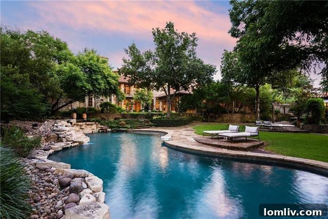 A view of the outdoor living spaces at 5019 Shadywood Lane, showcasing one of the covered terraces and the lush backyard landscape.