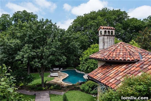 The exterior of the luxury estate at 5019 Shadywood Lane, showcasing its Tuscan Mediterranean architecture, lush landscaping, and mature trees. Designed by Robbie Fusch and built by Randy Hughes, this Dallas home is a true masterpiece.