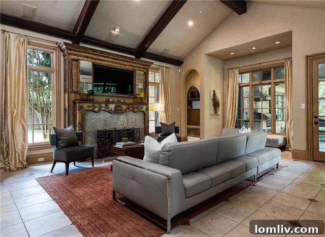 The elegant study at 5019 Shadywood Lane, featuring rich wood paneling, a cross-beamed ceiling, and bookcases, with French doors opening to a tranquil Zen garden.