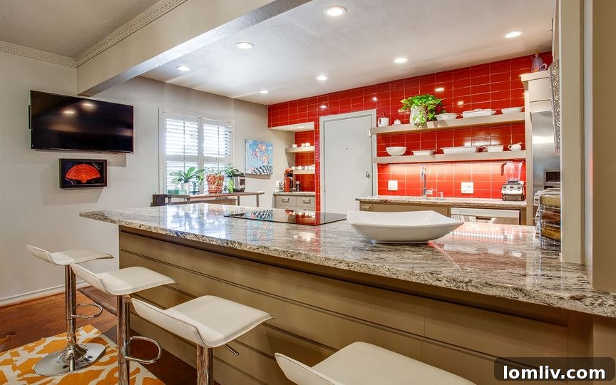 Discover 13 Exclusive Homes Behind The Pink Wall This Sunday 7 Bold red tile kitchen with spacious peninsula at 6307 Bandera Ave. Unit 6307 C