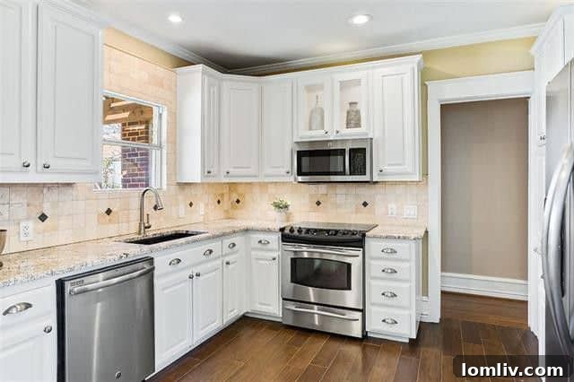 Updated kitchen with bright cabinets and stainless steel appliances