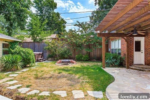 Spacious backyard with pergola, hot tub, and privacy fence