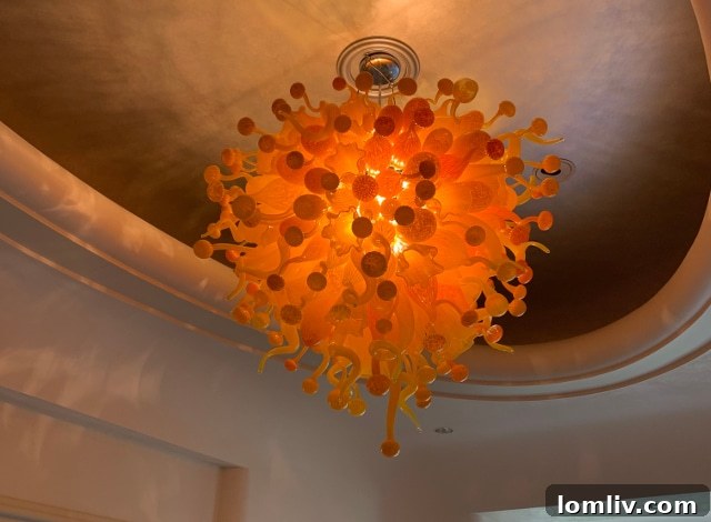 Zenith Zing Reclaimed Revelry 3 Vibrant red and orange molten glass chandelier, resembling a fiery cascade