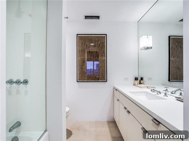 Gold Crest Studio: Your Architectural Sanctuary 7 Stylish bathroom with contemporary fixtures and clean lines