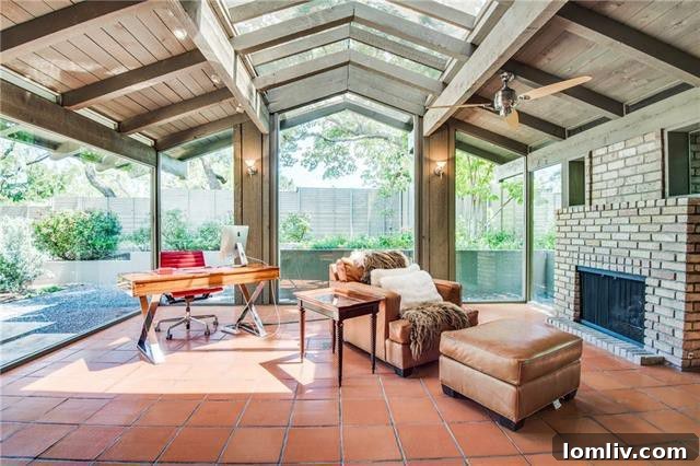 Expansive living room with large windows overlooking lush greenery