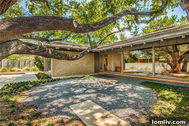 Exterior shot of the Midcentury Modern home, emphasizing privacy berms
