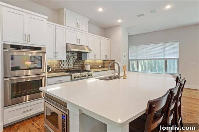 Spacious open-concept living area with abundant natural light and a view of the backyard