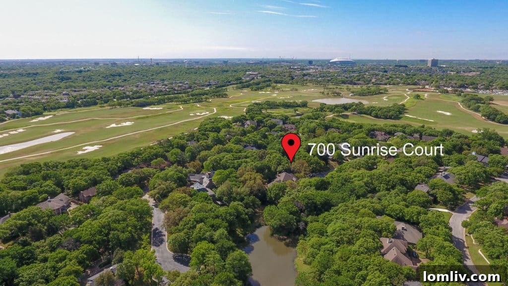 Aerial view showcasing the exclusive privacy of 700 Sunrise Court, surrounded by lush trees and manicured gardens