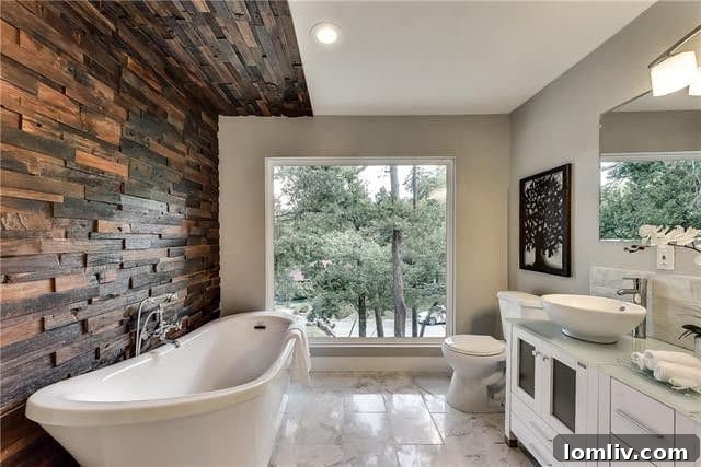 Luxurious master bathroom with marble flooring and large picture window