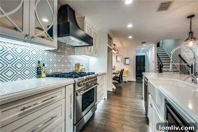 Modern kitchen with mirrored cabinetry and stylish backsplash