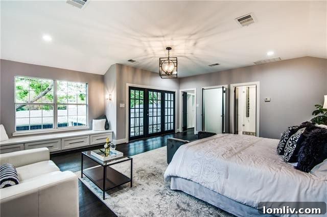First-floor master bedroom with hardwood floors and patio access