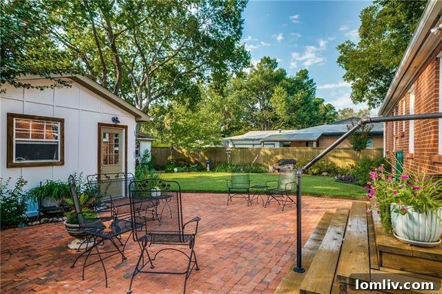 Spacious rear view of 6664 Santa Anita Drive, highlighting the two-car and separate one-car garages with secure electric gate access.