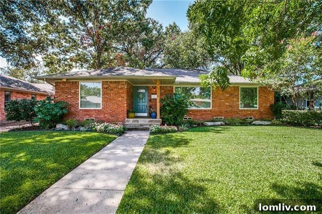 Lush front yard and traditional brick exterior of the renovated ranch home at 5215 Rexton Lane, Ridgewood Park.