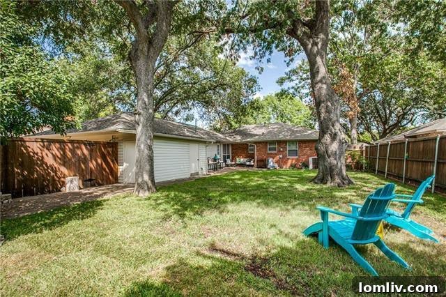 Expansive oversized backyard with a flagstone patio, perfect for entertaining and family activities at 5215 Rexton Lane.