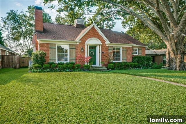 Stately brick home at 6664 Santa Anita Drive with a manicured lawn and a vibrant kelly green front door.