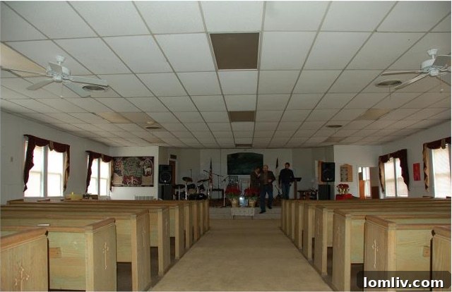 AIA Dallas Celebrates Local Architectural Excellence 6 Interior of the former Davis Street Baptist Church before renovation, showing a dropped ceiling and fans.