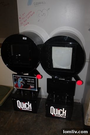 Letter Q-shaped Quick DFW Newspaper Rack