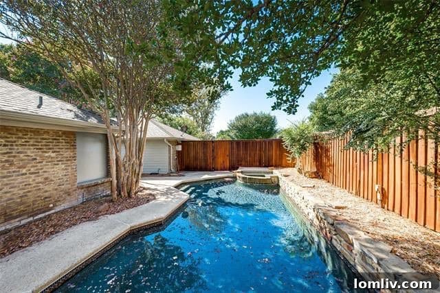 Exterior view of the updated Plano home featuring a shaded pool