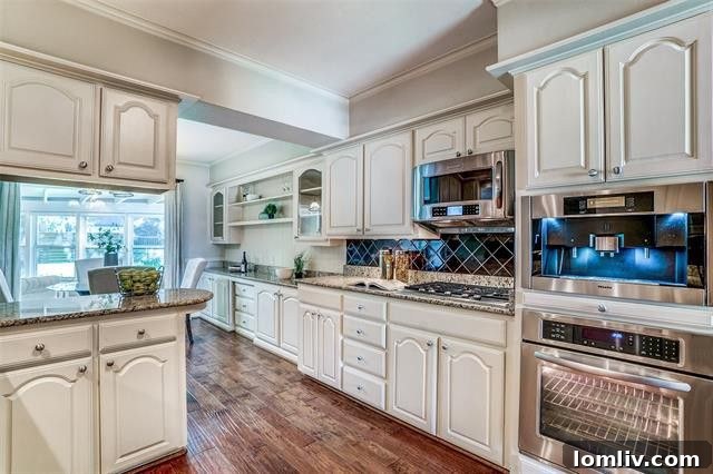 Stylish eat-in kitchen with granite countertops and Miele coffee center