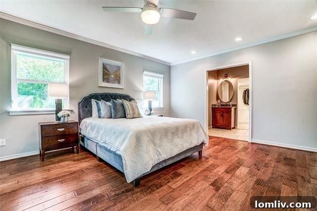 Luxurious master bathroom with dual vanities and glass-tiled shower