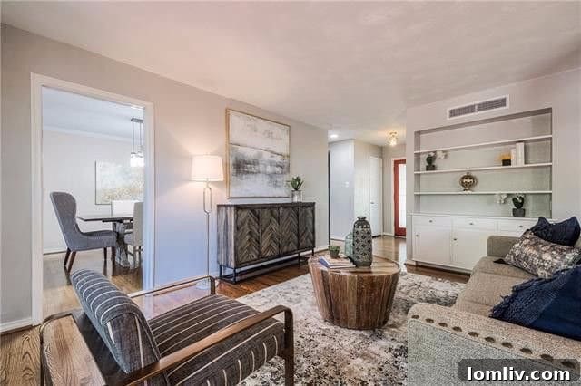 Interior view of a living room with hardwood floors and built-in shelves