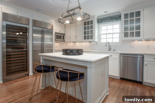 Well-equipped kitchen at 3720 Cresthaven Terrace featuring ample counter space, a full-size refrigerator, and a dedicated large wine fridge, ideal for entertaining.