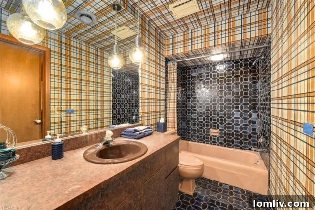 Retro Bathroom Design with Contrasting Patterns and Vintage Fixtures