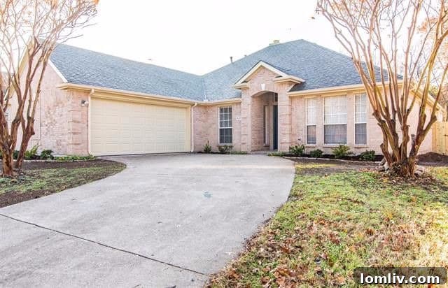 Exterior view of a modern single-story home with a curved driveway and inviting entryway in Rockwall, TX.