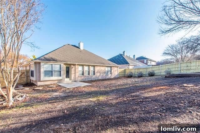 A large, private backyard with a new fence, offering ample space for recreation and relaxation.