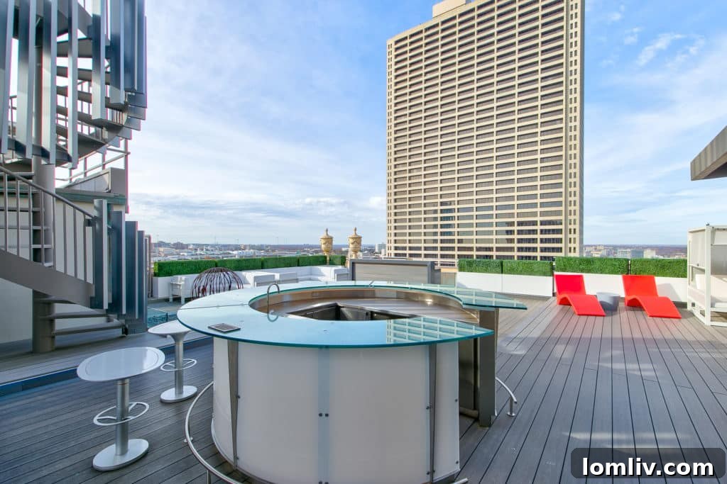 Stylish circular bar on penthouse rooftop, with a spiral staircase leading to an observation tower for elevated city views.