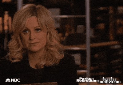 Home office or library space adorned with an eye-catching statue and abundant books.