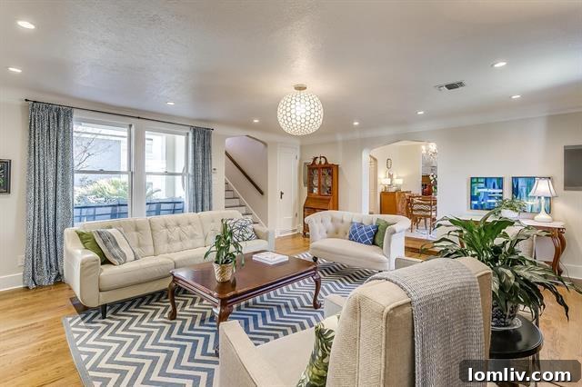 Spacious den with a comfortable sofa, fireplace, and a secondary staircase, ideal for relaxation