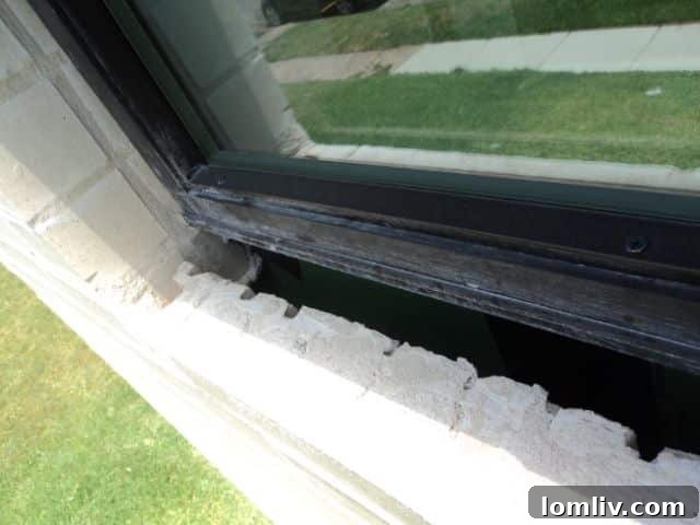 A newly constructed townhome window with clearly visible missing sills on the exterior, exposing the underlying structure.