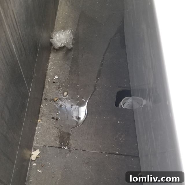 Close-up of a luxurious bathtub in a new home, revealing completely unconnected plumbing pipes underneath, a serious installation error.