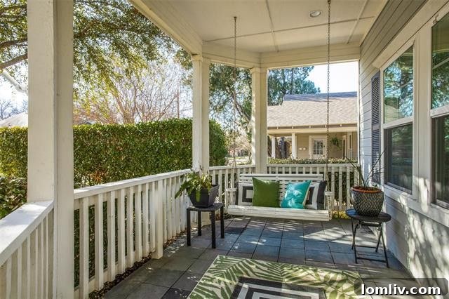 Welcoming front porch with swing and ceiling fan at 5345 Goodwin Avenue
