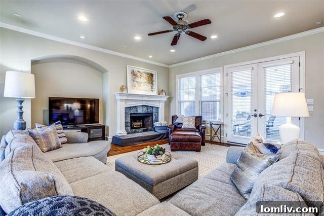Spacious living room with fireplace and ample natural light in a Dallas Craftsman home