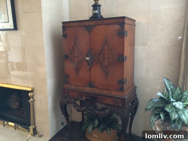 Elegant standing chest with intricate details, positioned symmetrically beside a fireplace in the expansive living room