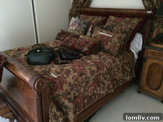 Upstairs bedroom featuring an impressive burled wood queen-size bed, ready for new linens to refresh its look