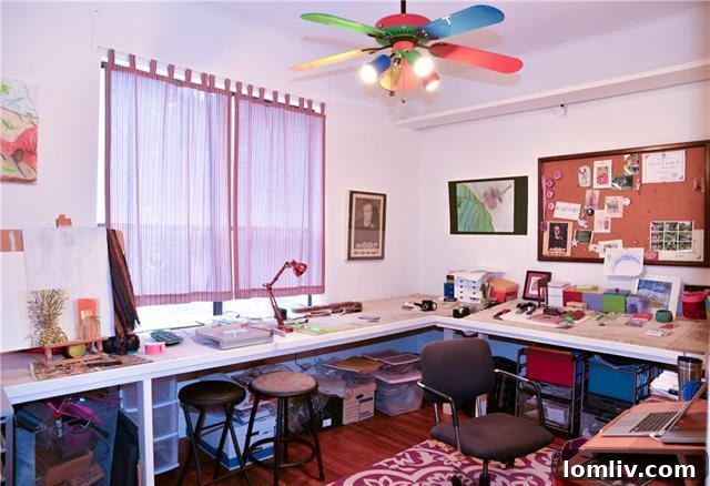 Home office or design studio, revealing clever decor choices and a pop art ceiling fan