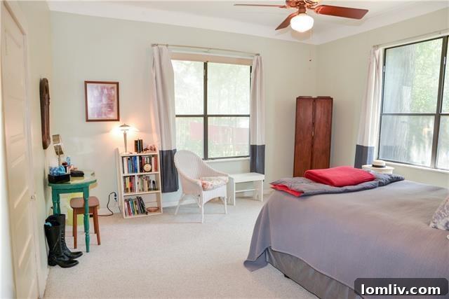 Serene pastel master bedroom featuring original 1921 four-panel doors and warm lighting