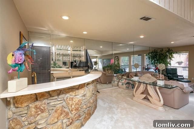 Elegant wet bar with stonework and refrigerator