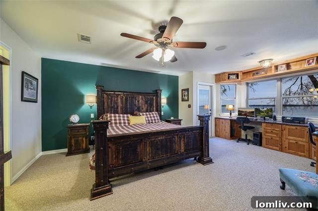 Tranquil master suite with built-in desk and panoramic lake views