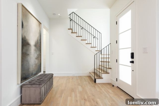 Bright white modern duplex interior with elegant staircase on Miller Avenue