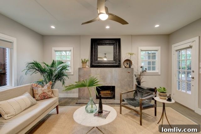 The living room at 3228 Wabash Avenue with a modern steel fireplace and symmetrical windows