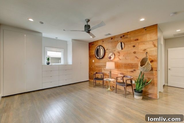 Master bedroom with shiplap accent wall and custom cabinetry